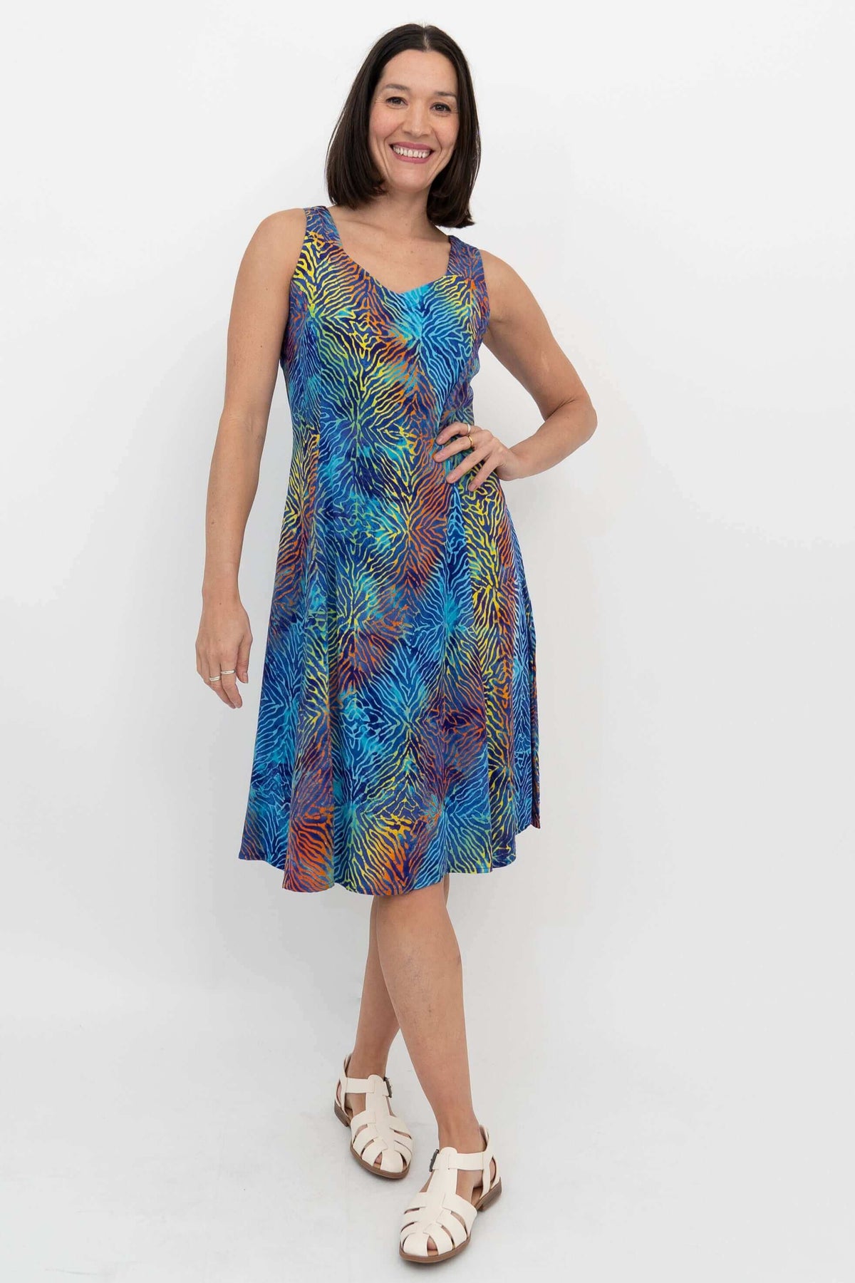 Woman wearing a vibrant blue and multicolor A-line summer dress with sweetheart neckline