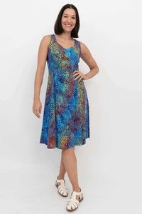Woman wearing a vibrant blue and multicolor A-line summer dress with sweetheart neckline