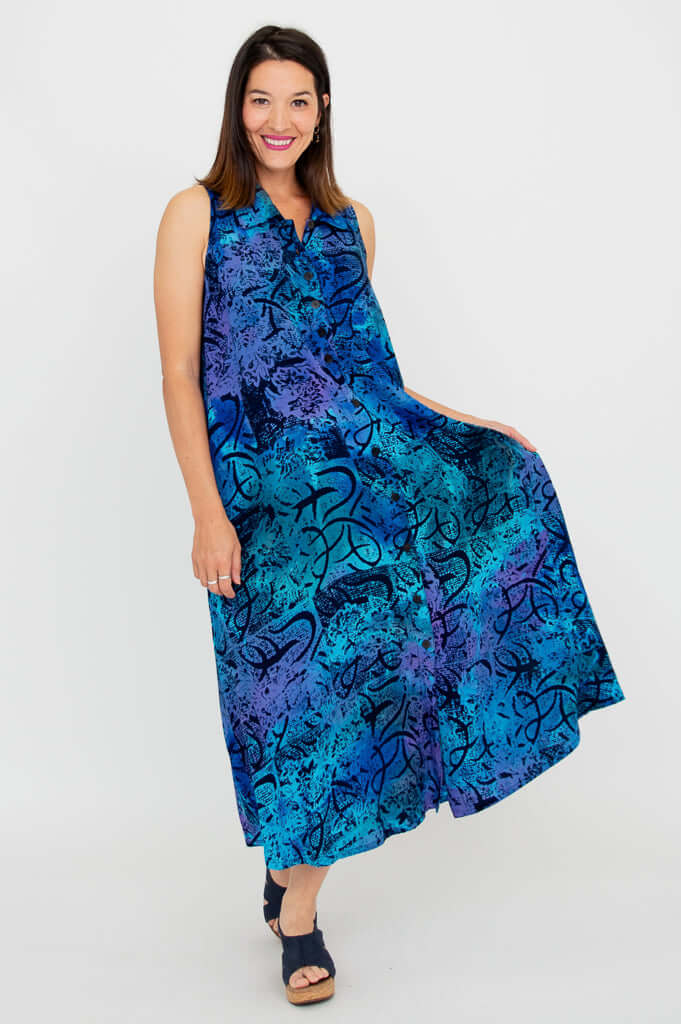 Woman showing off the swing and flare of a sleeveless blue A-line dress with a playful pose