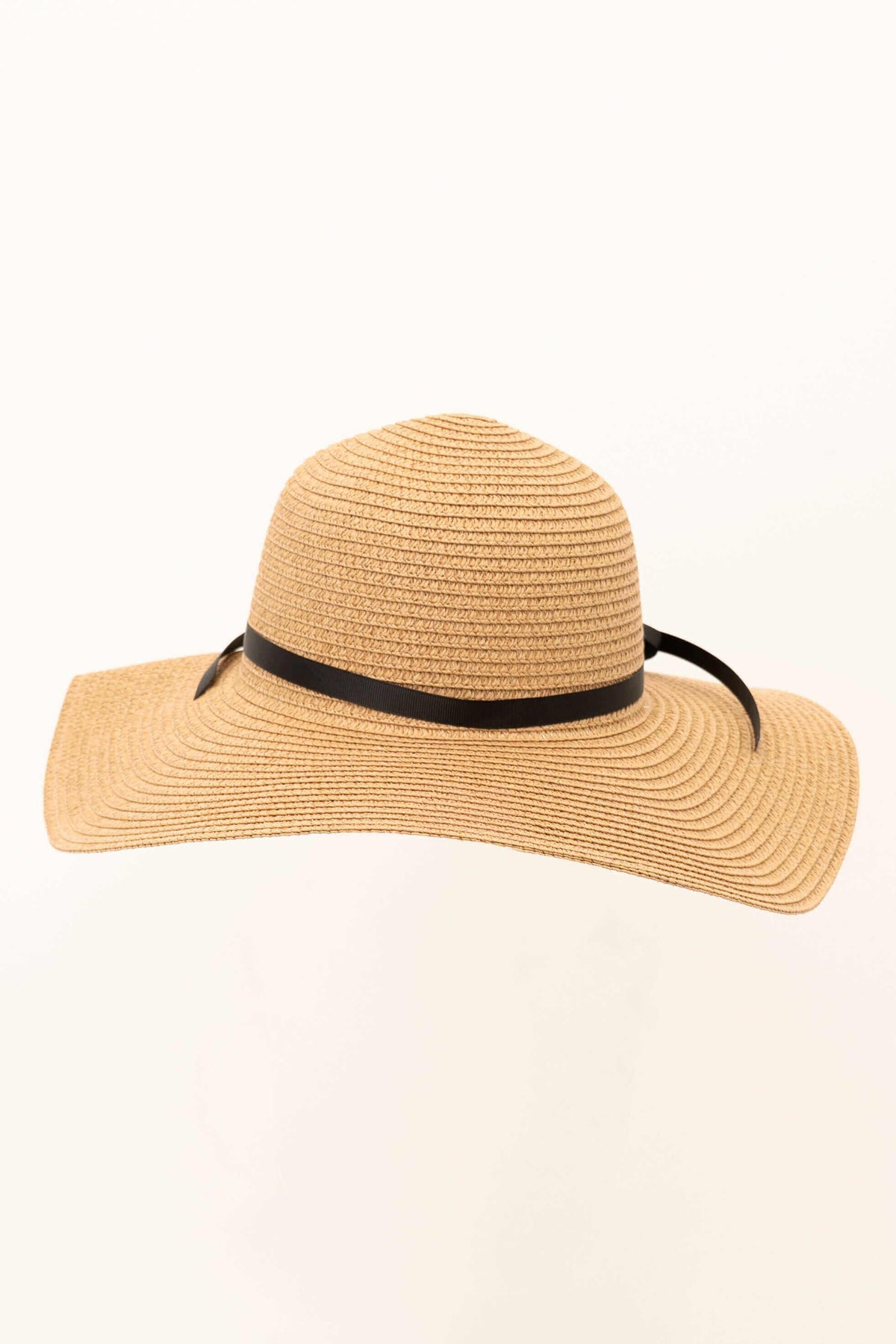Tan wide brim floppy sun hat with black ribbon accent