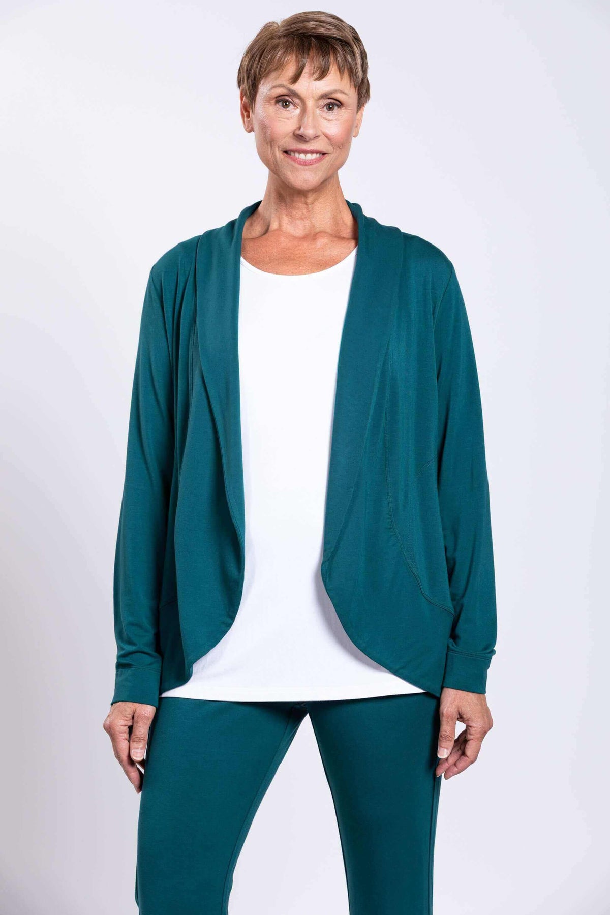 Woman wearing a teal French Terry jacket with shawl collar and open front