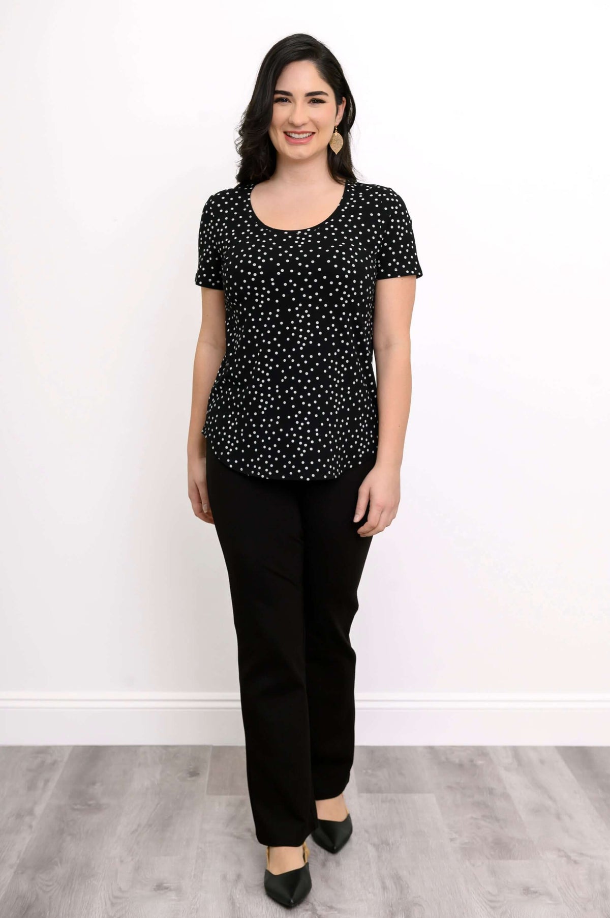 Model standing in black polka dot Tessa Tee and black pants