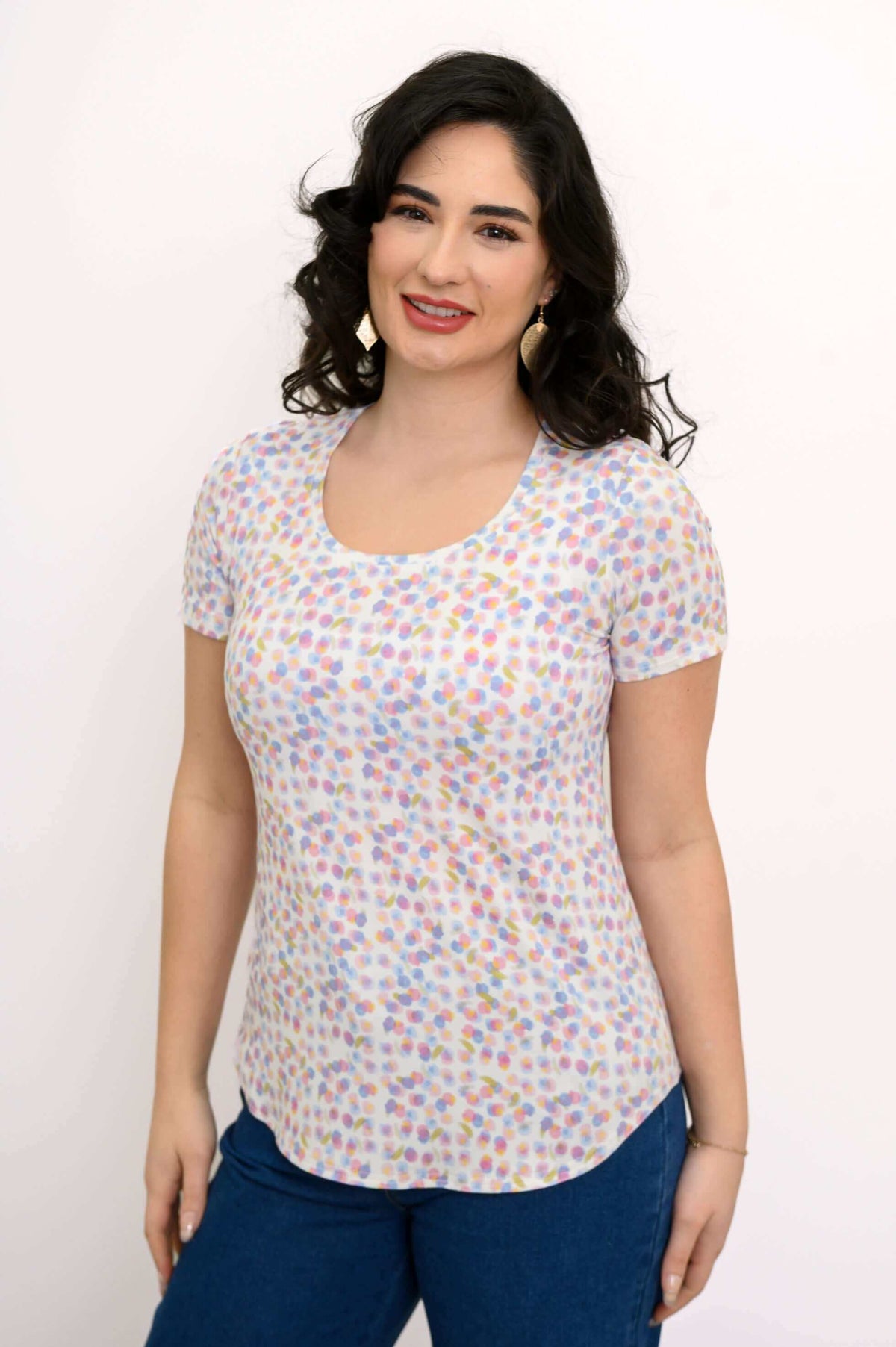 Woman wearing a Tessa Tee in confetti dot print, short sleeves and scoop neck