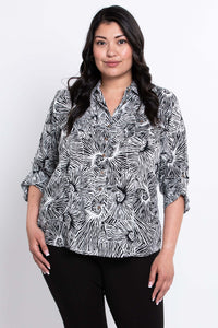 Front view of model wearing The Wendy black and white print blouse with rolled sleeves