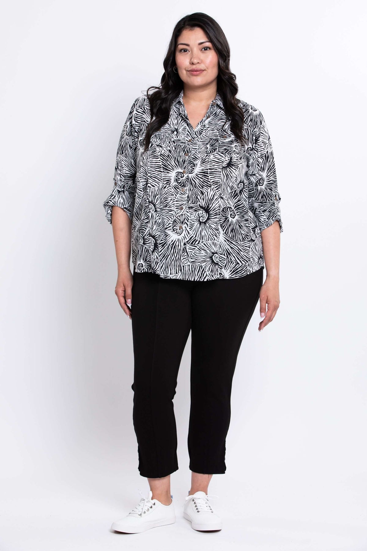 Full front view of model in The Wendy black and white patterned blouse and black pants