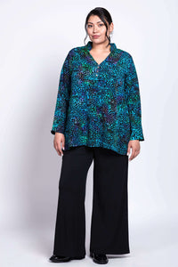 Three-quarter front view of Shirley Blouse Mosaic Indigo paired with black trousers