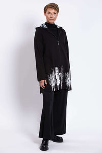 Three-quarter front view of Edith Coat displaying zip and tree border details