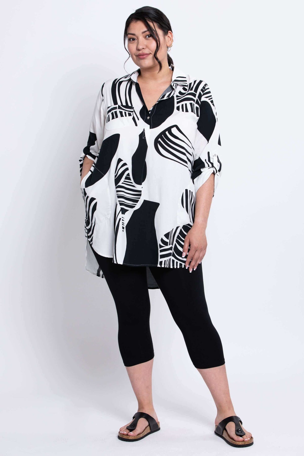 Three-quarter front view of Queenie Tunic styled with black leggings