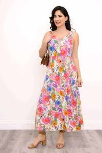 Three-quarter front view of woman modeling a colorful floral maxi dress