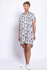 Three-quarter view of a woman in high-low hem and floral print dress