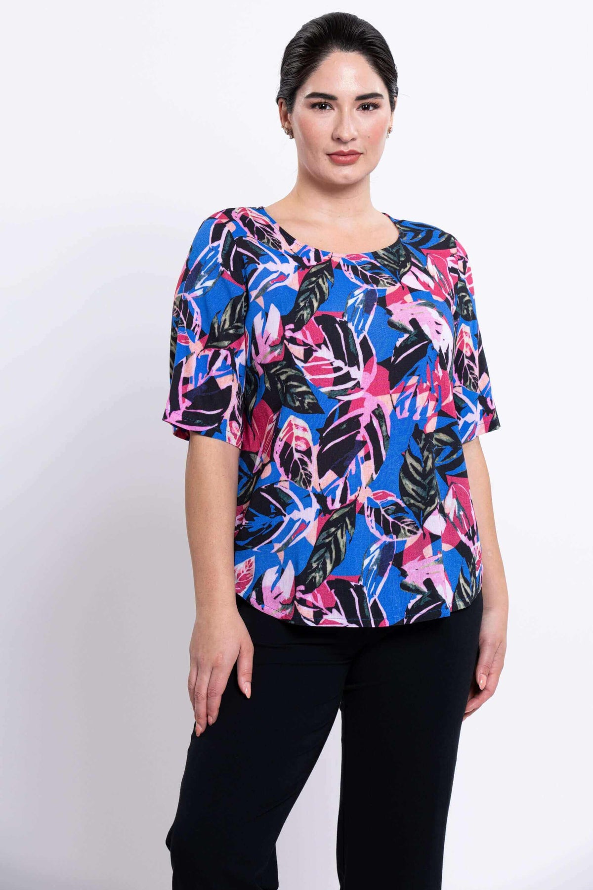 Three-quarter view of Liza blouse with pink and blue tropical leaves