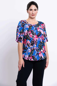Three-quarter view of Liza blouse with pink and blue tropical leaves