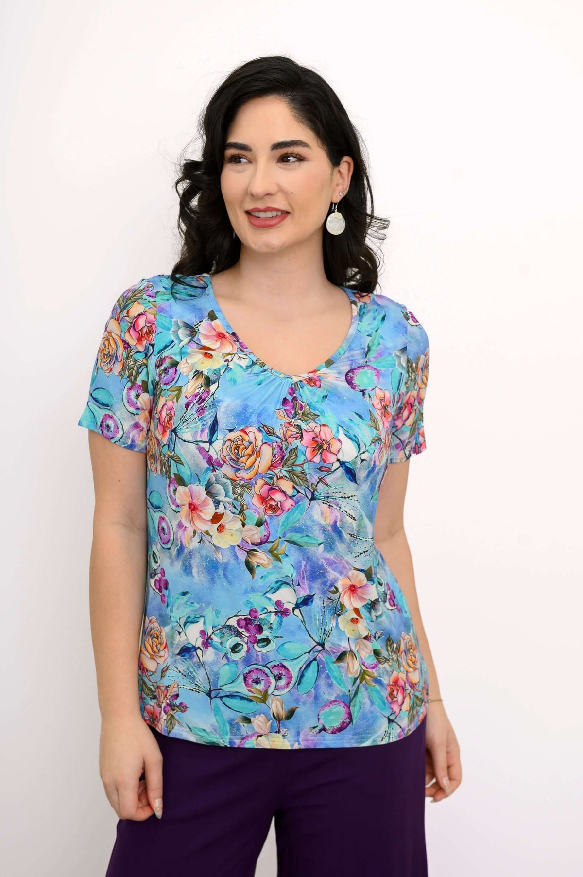 Three-quarter view of a woman in a blue floral bamboo top