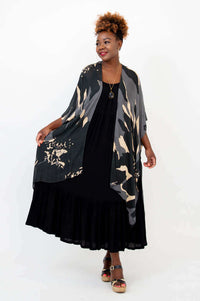 Three-quarters view of Darcy kimono wrap styled open over black maxi dress