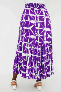 Rear view of a model wearing the Tibby maxi skirt in purple and white with tiered design
