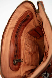 Top view into the bag highlighting inner zippered pocket and card slots