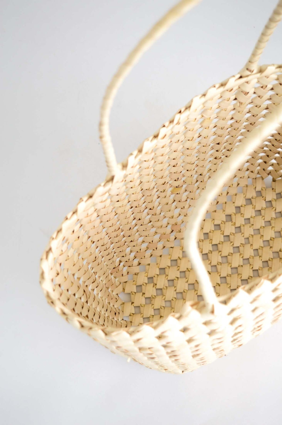 Top view of spacious hand woven rattan tote showing interior