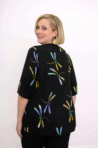 Back view of a woman displaying the dragonfly pattern on the Toucan Jacket