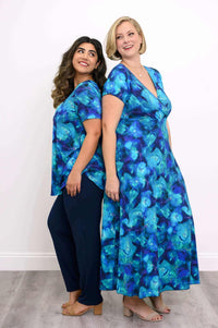 Two models: one in blue floral bamboo maxi dress, one in matching blue floral top and navy pants