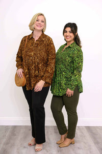 Two women modeling smocked button-up tops in autumn gold and green prints