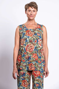 Woman wearing a sleeveless tank top and pants set in a vibrant vintage floral print, front closeup view
