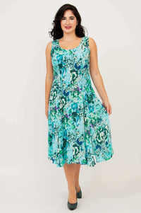 Front walking view of a woman in a sleeveless aqua bamboo linen dress