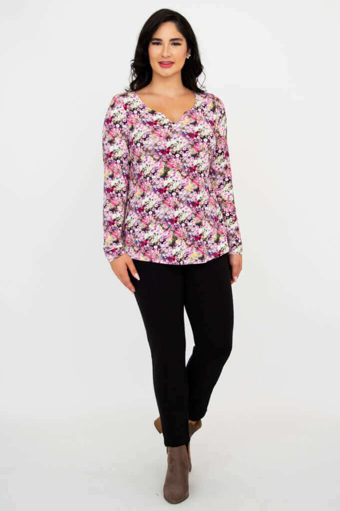 Woman walking in floral sweetheart neckline bamboo top and black pants