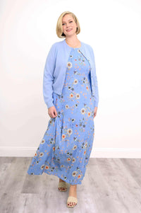 Model in blue floral maxi dress and light blue cardigan walking