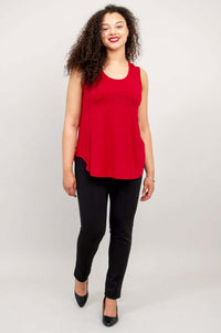 Model walking forward wearing a cherry red Jazz Bamboo Tank Top with black dress pants