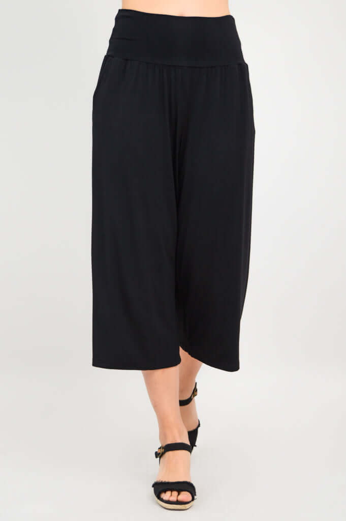 Walking view of black Gaylene bamboo capri pants