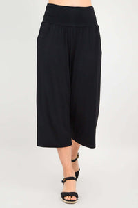 Walking view of black Gaylene bamboo capri pants