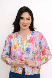 Woman wearing a vibrant watercolor floral cardigan, close-up front view
