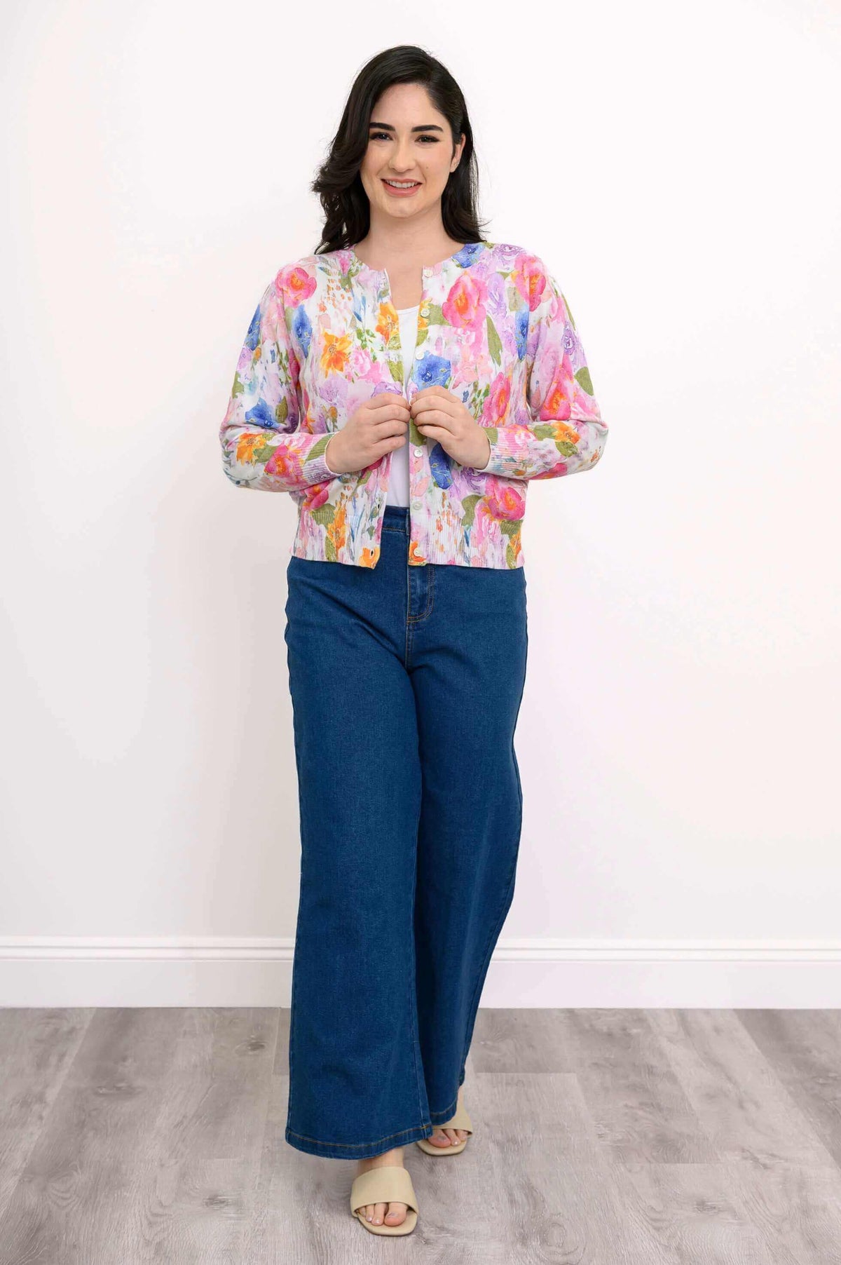 Woman modeling watercolor floral cardigan with wide-leg jeans, full body front view