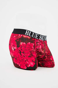 Side angle of men's boxer briefs showing bold red floral pattern and black waistband