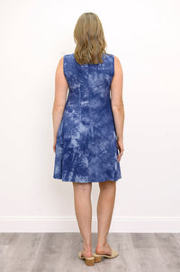 Back view woman wearing sleeveless blue tie dye short dress and sandals on a white background