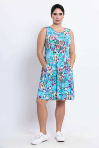 Front view of model in Willow Floral Aqua Dress with hands in pockets