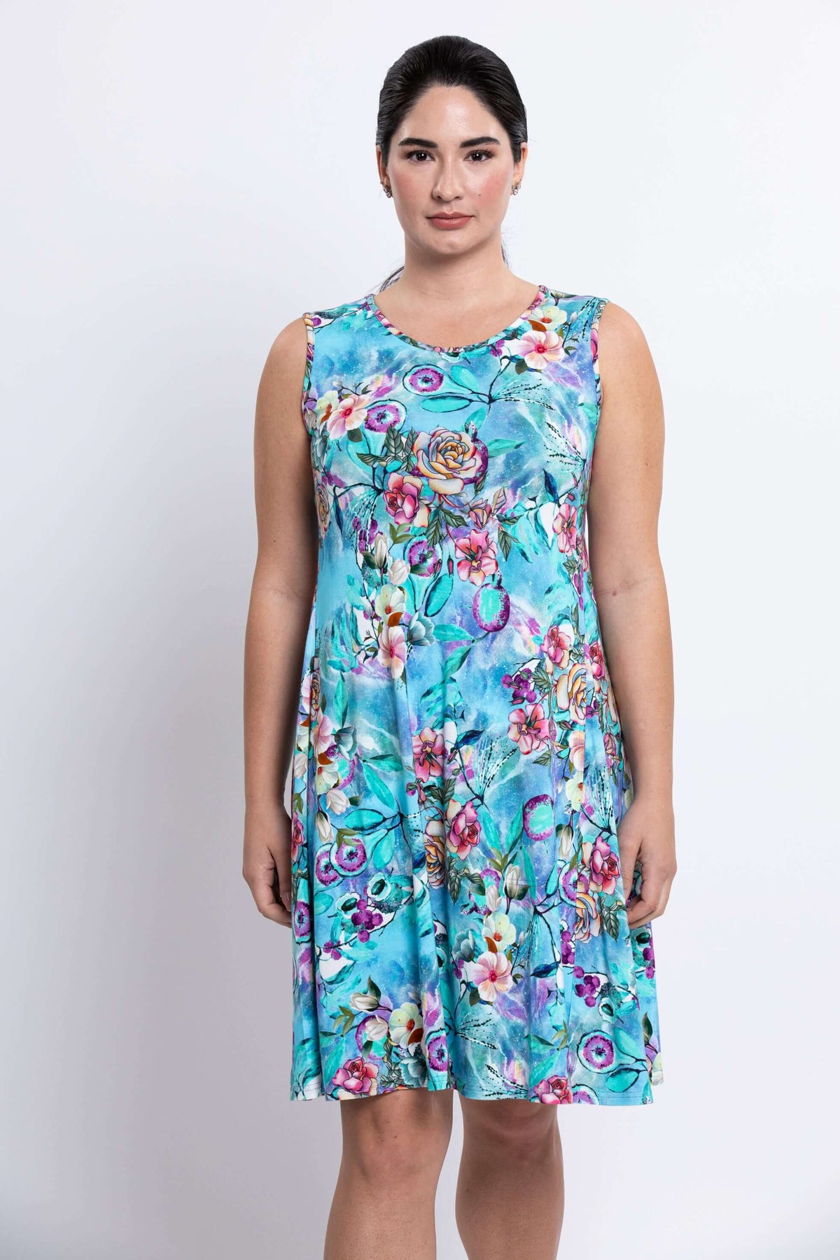 Front view of woman wearing a sleeveless blue floral dress with floral print