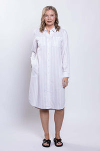 Woman facing forward in a striped shirt dress with long sleeves and pockets