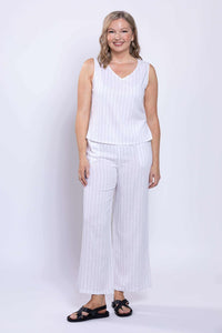 Woman facing forward, smiling, in white striped sleeveless linen blend top and pants set