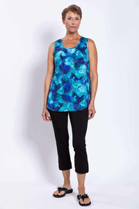 Woman facing forward wearing sleeveless blue bamboo Jazz Tank and black pants