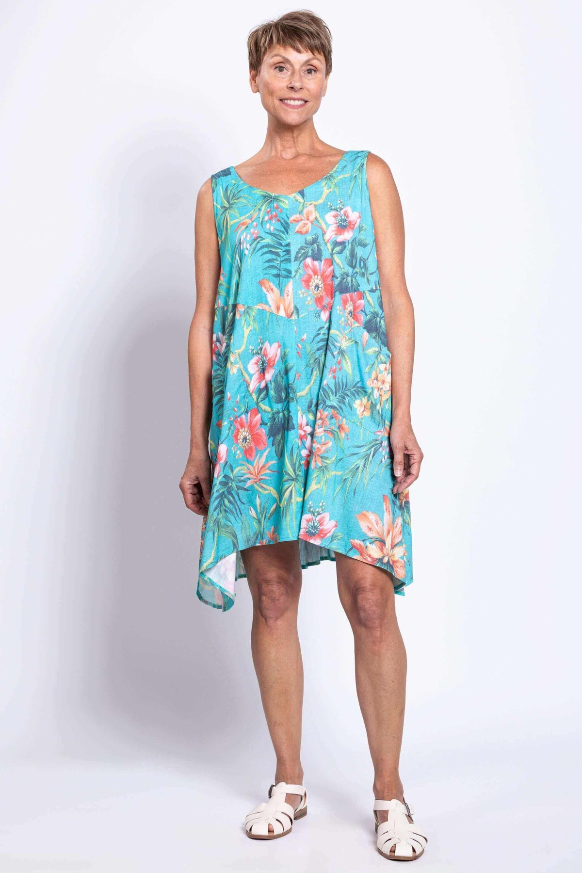 Woman in  Dress showing floral print and uneven hem from the front