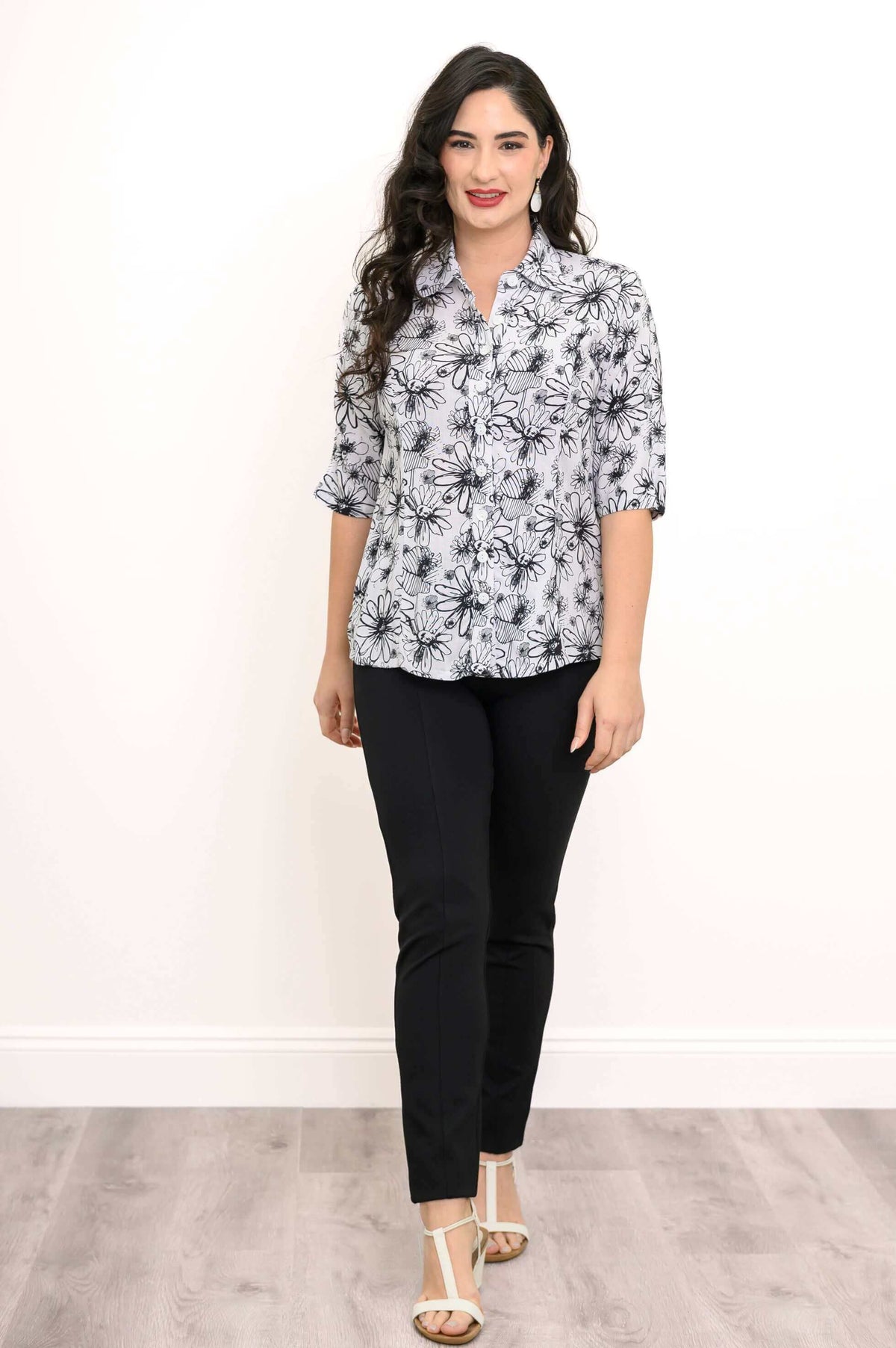 Woman in a floral bamboo-linen blouse standing with white heeled sandals