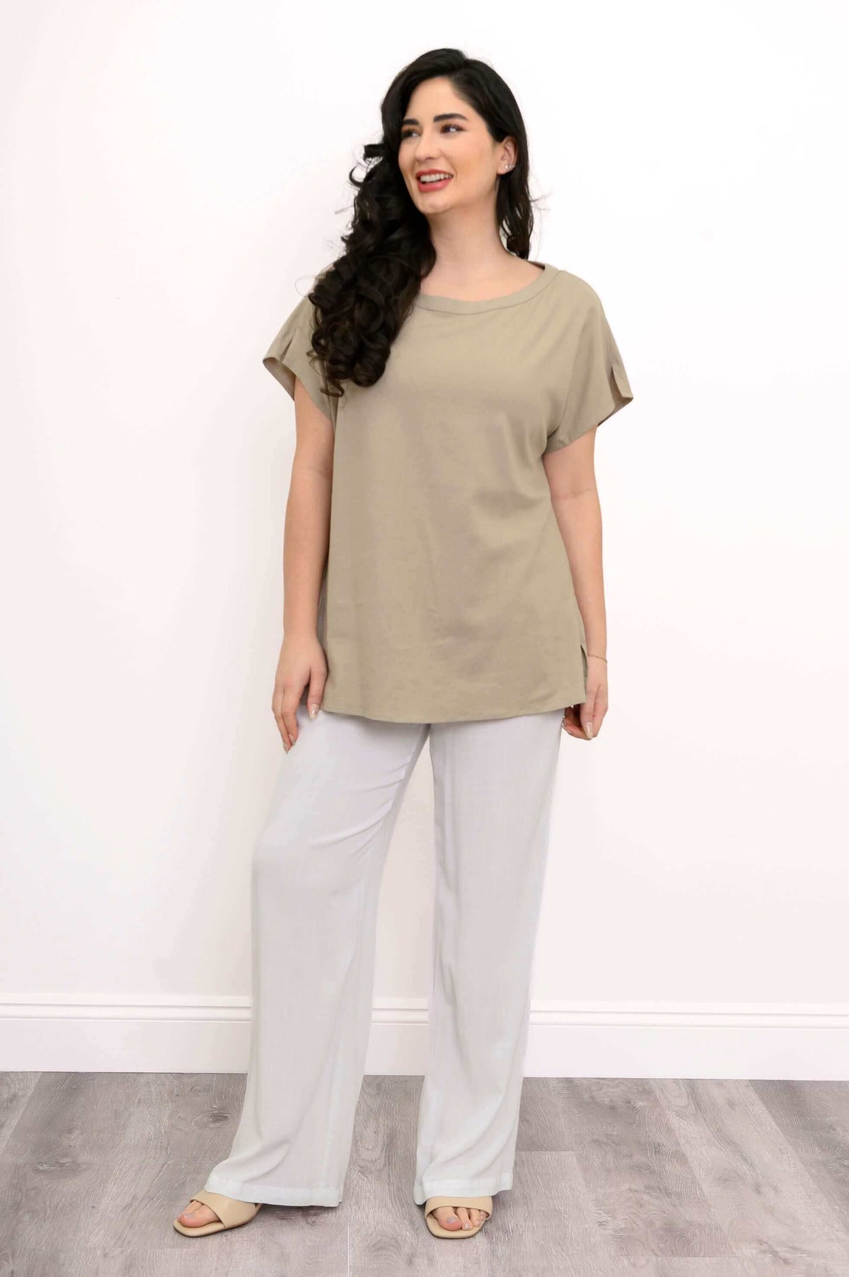 Woman in beige dolman sleeve tee looking to the side