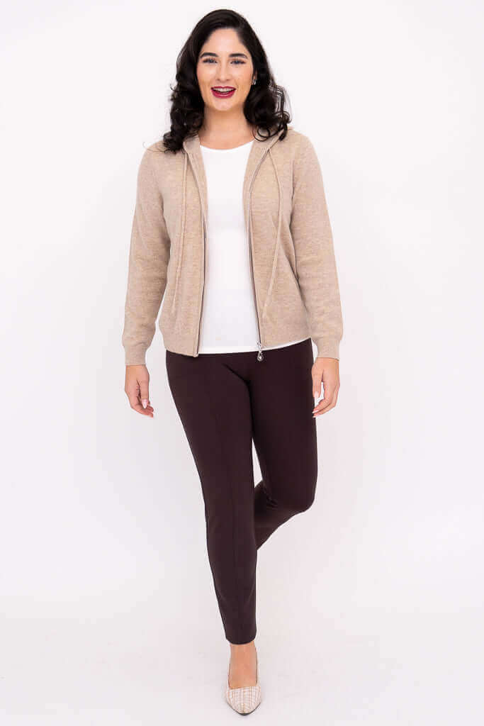 Woman smiling in beige zip hoodie, walking forward, full body front view
