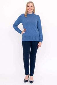 Woman in blue cotton sweater and navy pants standing, full front view