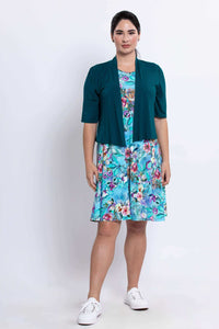 Woman wearing blue floral dress paired with teal short-sleeve jacket