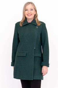 Woman wearing a dark green wool coat, smiling and facing forward