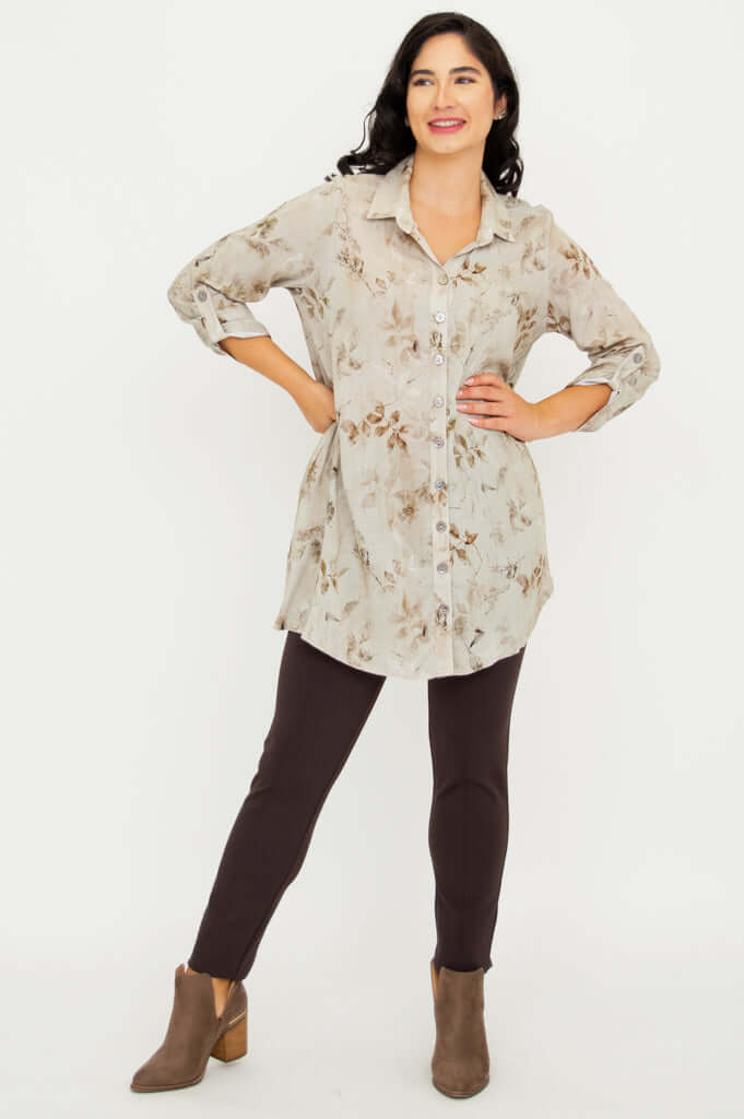 Woman smiling in bamboo linen tunic with sleeves rolled up and hands on hips