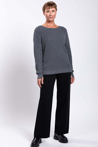 Woman in gray shaker stitch sweater with subtle ribbing and classic fit