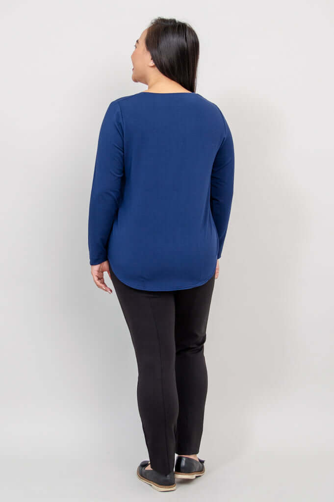 Woman in navy blue long sleeve top, back view